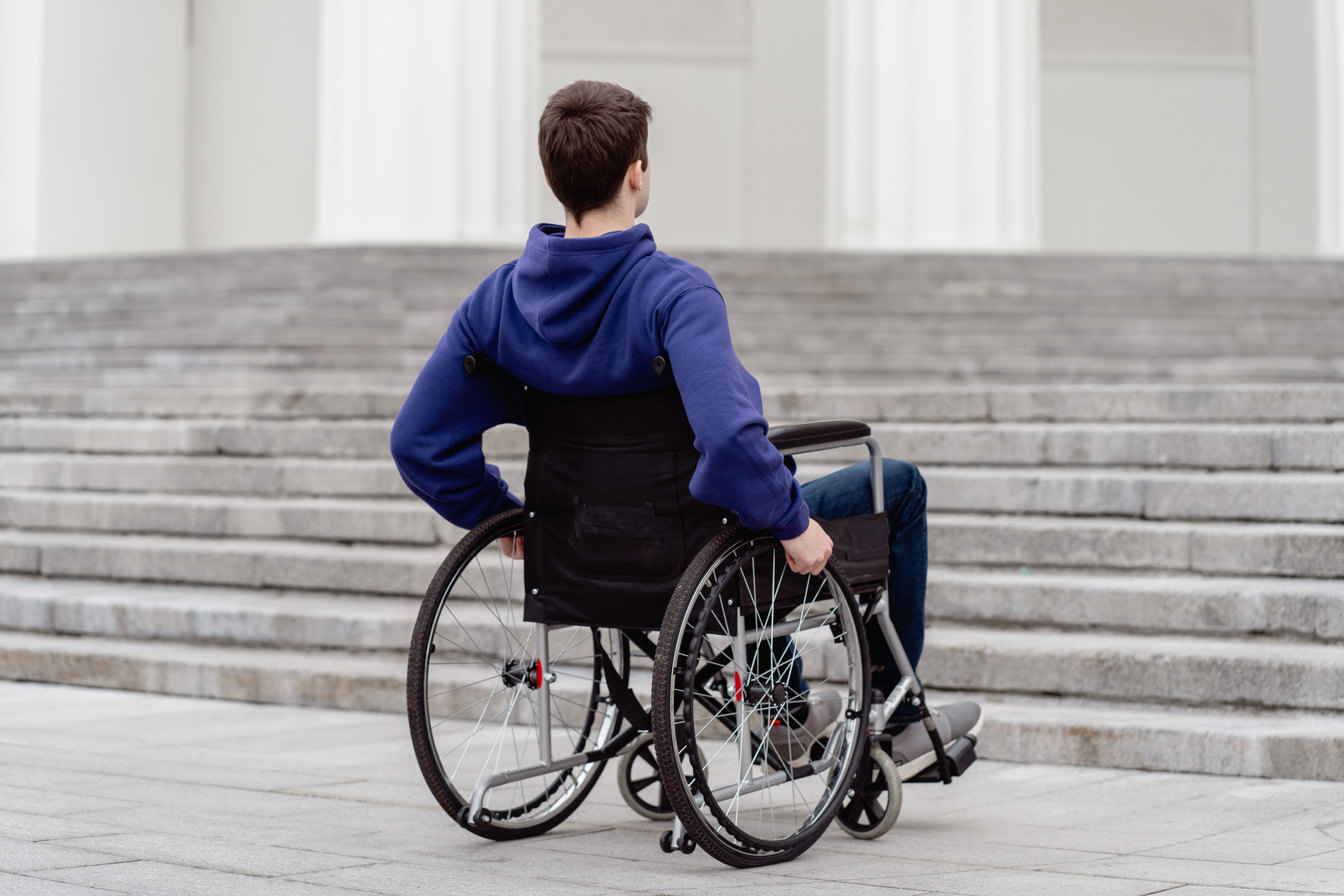 Close-Up Shot of a Man Sitting on a Wheelchair